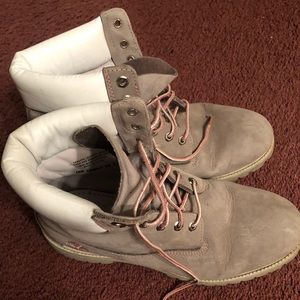 Men’s grey Timberland boots with pink accents.